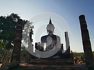 A World Herritage Buddha in Thailand with a sun set and silhouette