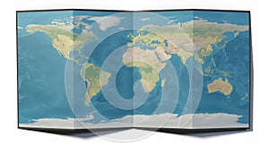 World map drawn on a folded sheet, planisphere leaning on a surface. Physical map photo