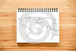 World map outline on notebook