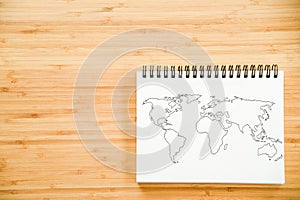 World map outline on notebook