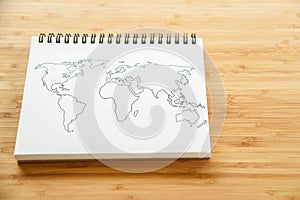 World map outline on notebook