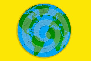 World Map Puzzle: Green Continents and Blue Oceans on Yellow Background