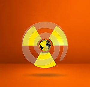 World map on Radioactive symbol. Orange studio background