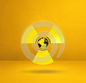 World map on Radioactive symbol. Yellow studio background