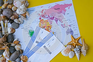 World map, seashells and pebbles boarding pass. Travel vacation concept. Summer sea holidays. Tourism and resorts.