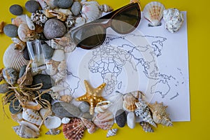 World map, seashells and pebbles boarding pass. Travel vacation concept. Summer sea holidays. Tourism and resorts.