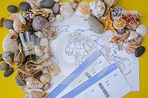 World map, seashells and pebbles boarding pass. Travel vacation concept. Summer sea holidays. Tourism and resorts.