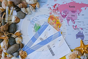 World map, seashells and pebbles boarding pass. Travel vacation concept. Summer sea holidays. Tourism and resorts.