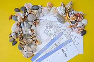 World map, seashells and pebbles boarding pass. Travel vacation concept. Summer sea holidays. Tourism and resorts.