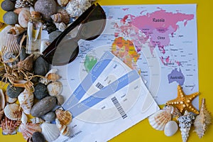World map, seashells and pebbles boarding pass. Travel vacation concept. Summer sea holidays. Tourism and resorts.