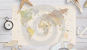 World map on a table surrounded by shells, compass, anchor and lifebelt
