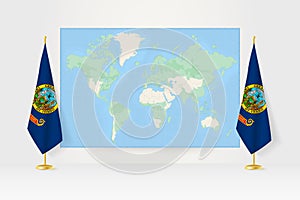 World Map between two hanging flags of Idaho flag stand