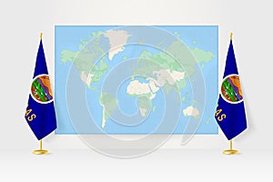 World Map between two hanging flags of Kansas flag stand