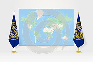 World Map between two hanging flags of Nebraska flag stand