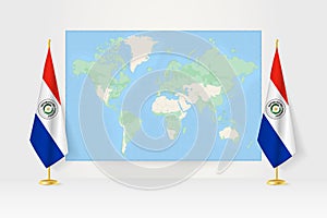 World Map between two hanging flags of Paraguay flag stand