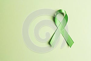 World mental health day concept. Green awareness ribbon with copy space for text