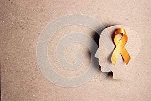 World Multiple Sclerosis Day. Orange awareness ribbon and brain symbol on a brown background