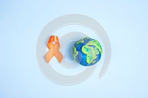 World Multiple Sclerosis Day. Orange awareness ribbon and planet Earth
