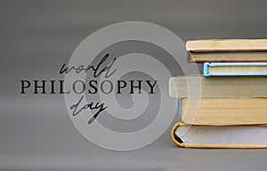 World Philosophy Day. Stack of books with pens and lettering on white background.