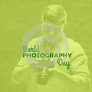 World photography day text on green with happy caucasian man looking at camera back