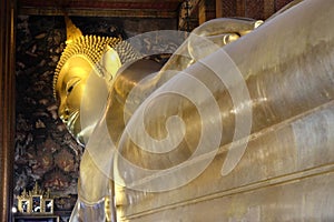 The world`s largest sculpture of a reclining Buddha in a temple in Bangkok