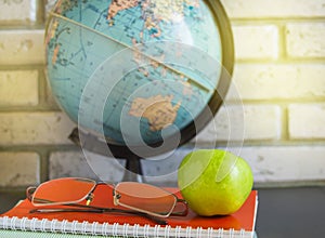 World teacher's Day at school. Still life with books, globe, Apple, glasses, sunlight