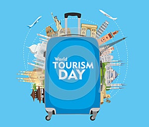 World Tourism Day. The inscription on the blue travel suitcase. Around the monuments of architecture