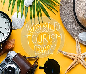 World Tourism Day Typography. Flat Lay Traveling Holiday Vacation Yellow Background photo