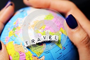 World travel concept with colorful globe in woman hand