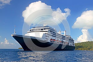 World voyage cruise ship at anchor off the beautiful tropical island of Bora Bora, French Polynesia