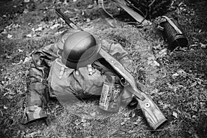 World War II German Wehrmacht Soldier Ammunition Of World War II On Ground. WWII Military Helmet, Lights, Rifle Mauser