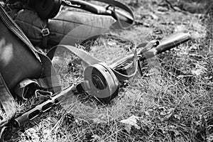 World War II Soviet Red Army Weapon. Submachine Gun PPSh On Ground. WWII WW2 Russian Ammunition. Photo In Black And