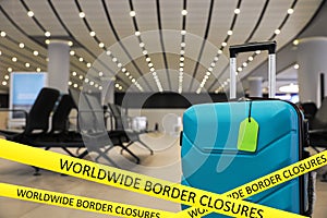 Worldwide border closures through quarantine during coronavirus. Suitcase in airport and yellow awareness ribbons