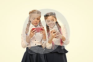 Worldwide net. Internet resource has hazards for kids. Girls school uniform surfing internet. Schoolgirls use mobile