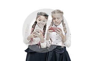 Worldwide net. Internet resource has hazards for kids. Girls school uniform surfing internet. Schoolgirls use mobile