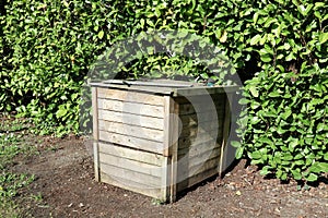 Worm composting wooden box in garden