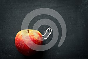 Worm looking out of Apple