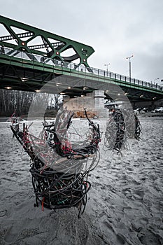 Worm made from cables as an art placed in sand