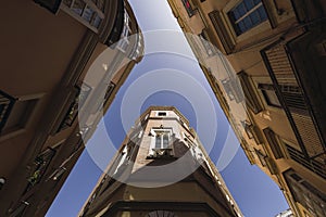 Worm's eye view of the streets featuring the tall buildings in Jerez, Spain