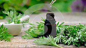 Wormwood extract in a small bottle. Selective focus.