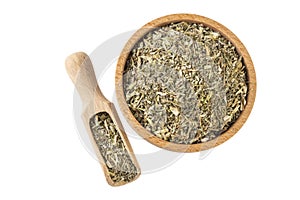 Wormwood herb or in latin Absinthii herba herb in wooden bowl and scoop isolated on white background. medicinal healing herbs.