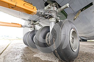 Worn aircraft chassis. Old tire in disrepair