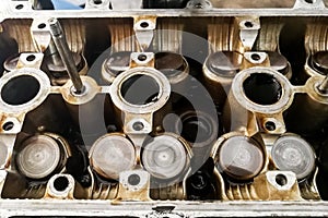 Worn auto car engine valves being serviced at garage photo