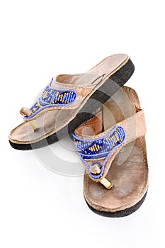 Worn beaded leather flops with rubber soles