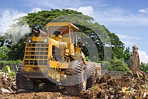 Worn bulldozer on tropical terrain