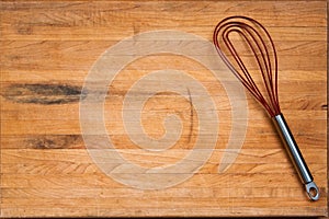 Worn Butcher Block Cutting Board with Wire Whisk