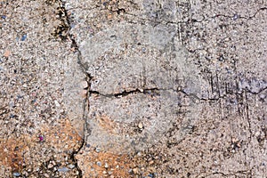 Worn and cracked asphalt with big cracks. Old road concrete texture with cracks. Cement cracked background