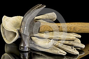 Worn hammer and old gloves