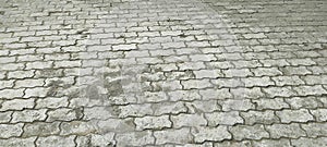 Worn Interlocking Concrete Pavement with Weathered Texture and Neutral Tones photo