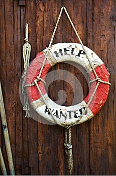 A worn life saver with the caption Help Wanted